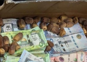 بالصور.. إحباط تهريب 1.65 مليون ريال داخل كراتين تمر وملابس في مطار المدينة